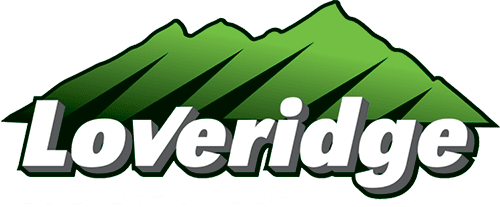 loveridge-logo-WEB-light Logo of Loveridge Builders & Roofing featuring the company name in white with a green mountain graphic in the background.